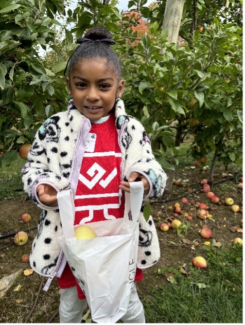 girl holding bag of apples